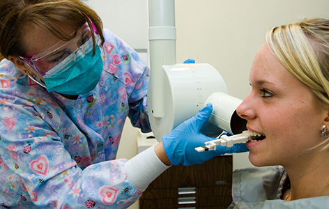 An NMC Dental Assistant Program instructor demonstrates a dental technique to a student