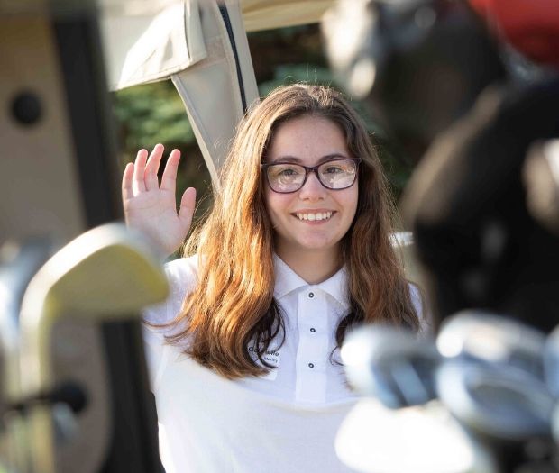 Student waving at the 2019 Scholarship Open