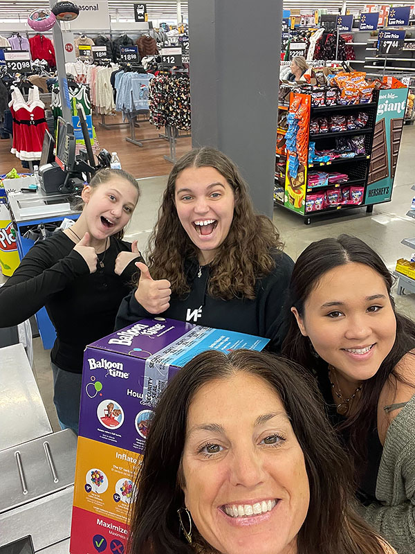 Business Instructor Kristy McDonald and her students shop for thanksgiving meal items as part of an experiential learning project.