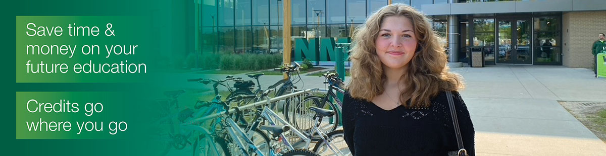 Smiling young woman standing in front of the Timothy J. Nelson Innovation Center on NMC's Front Street campus