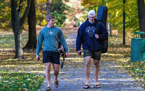 Two students walk on a path on NMC's Front Street campus