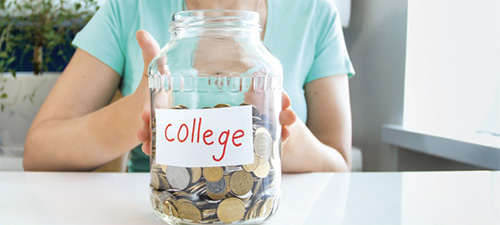 Photo of a glass jar marked "college" containing loose change