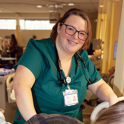 An NMC nursing program student smiles in a hospital