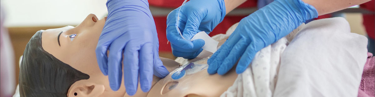 Nursing students working on a CPR mannequin