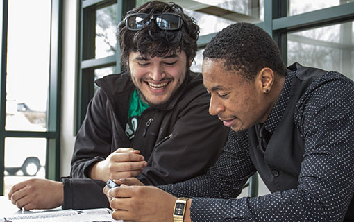 Two NMC students in an East Hall dorm room