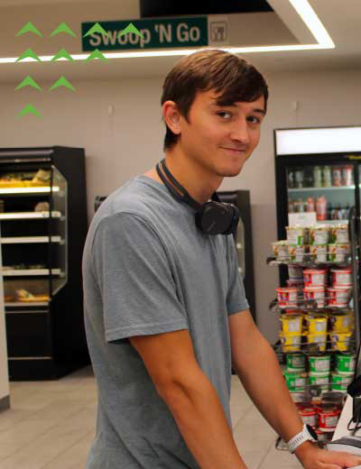 A smiling NMC student in the Hawk Owl Cafe